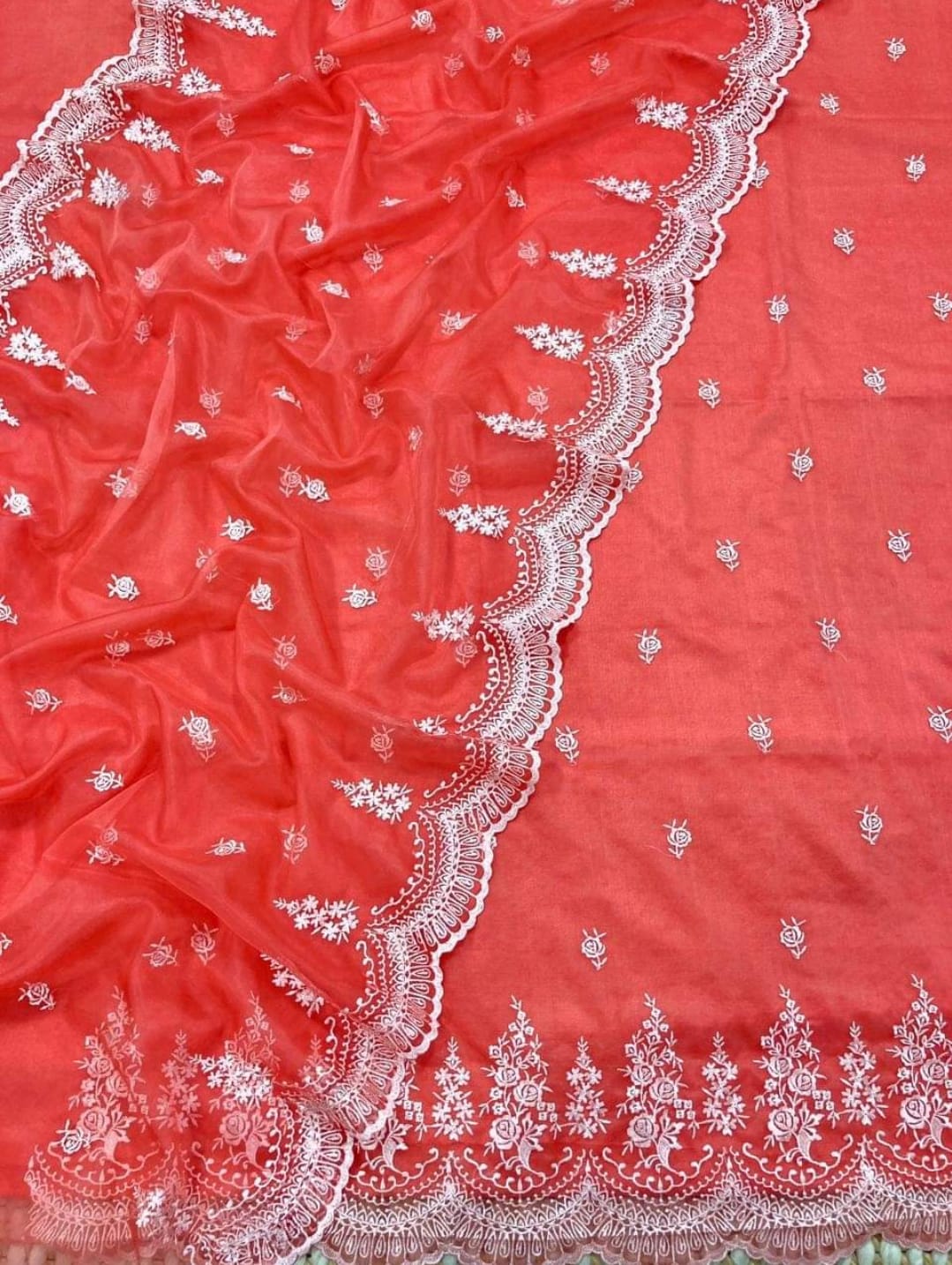 Red fabric with white embroidery