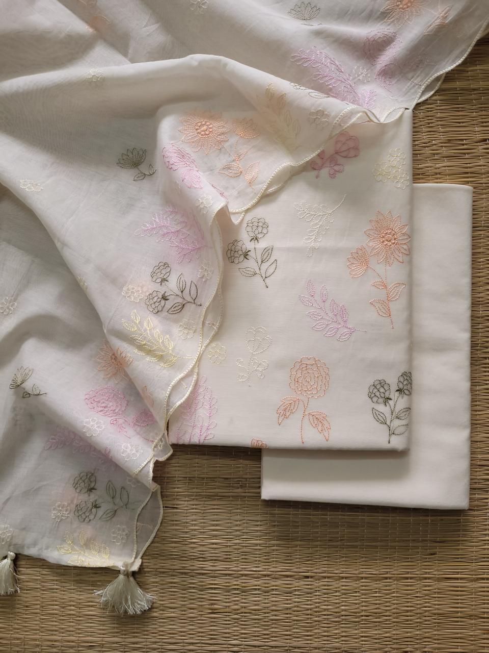 Floral-patterned fabric with tassels on a wooden surface