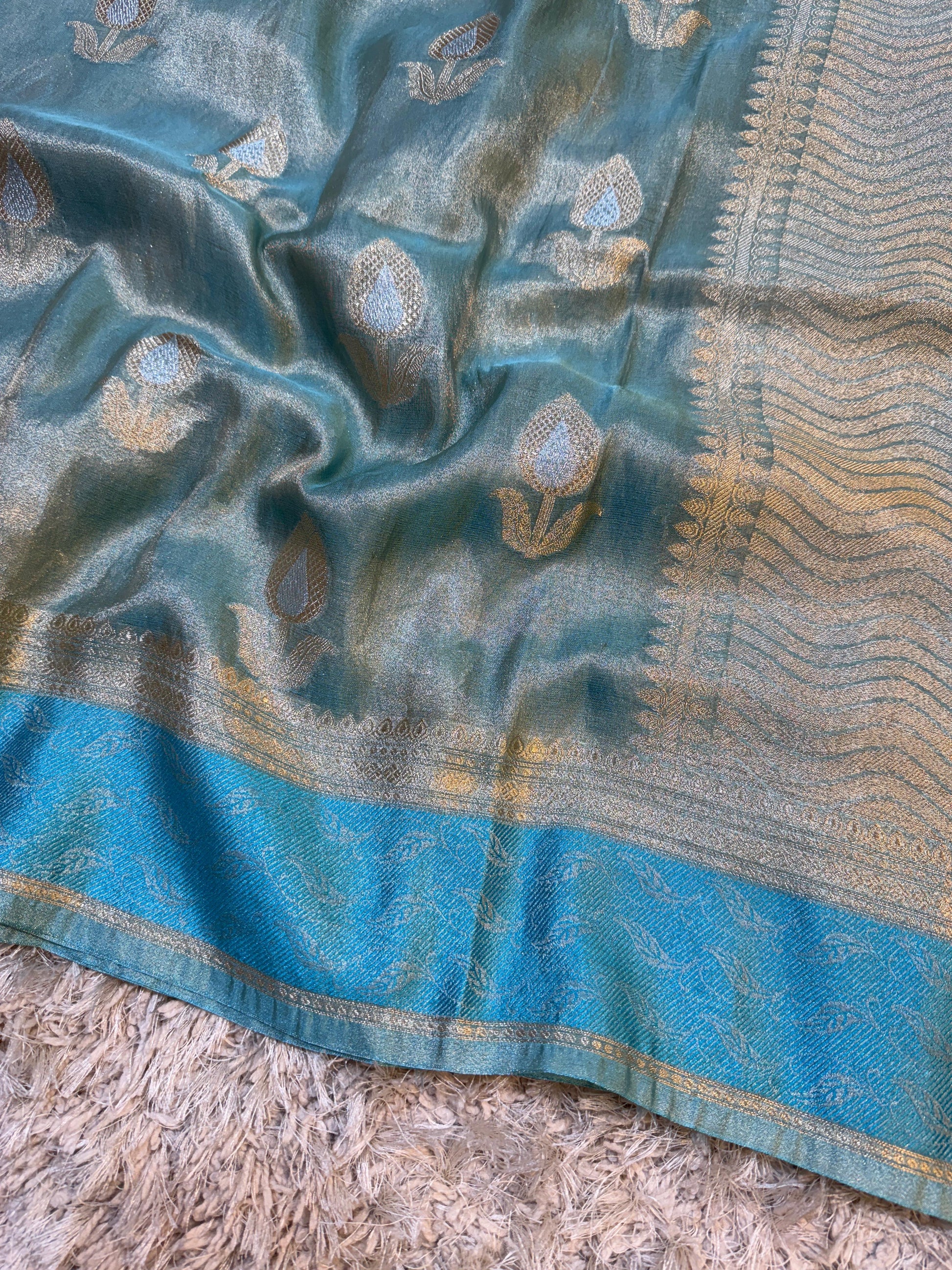 Blue fabric with intricate patterns on a textured surface