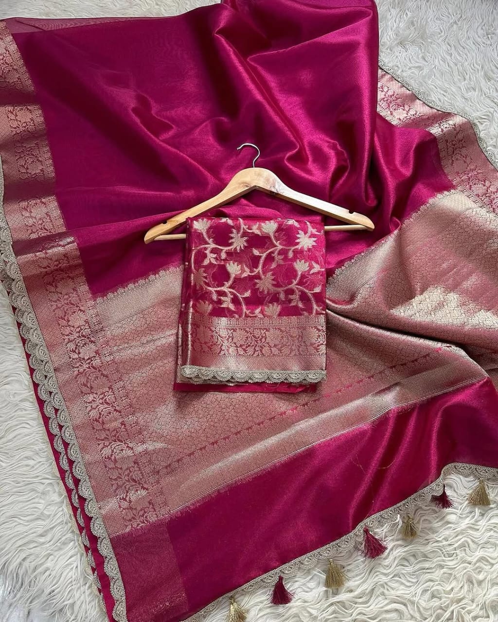Pink saree with a matching blouse on a white textured surface
