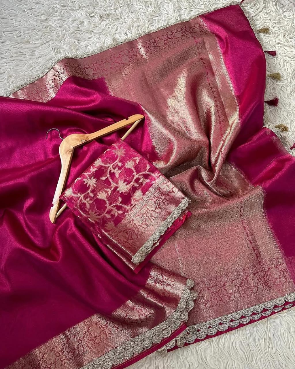 Pink saree with lace detailing on a textured surface
