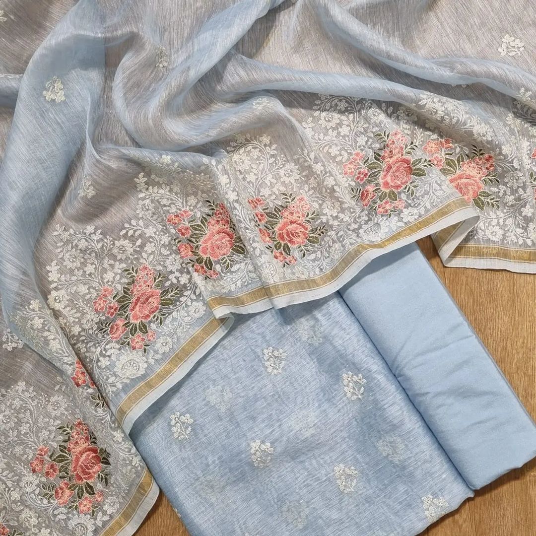 Embroidered fabric with floral patterns on a wooden surface