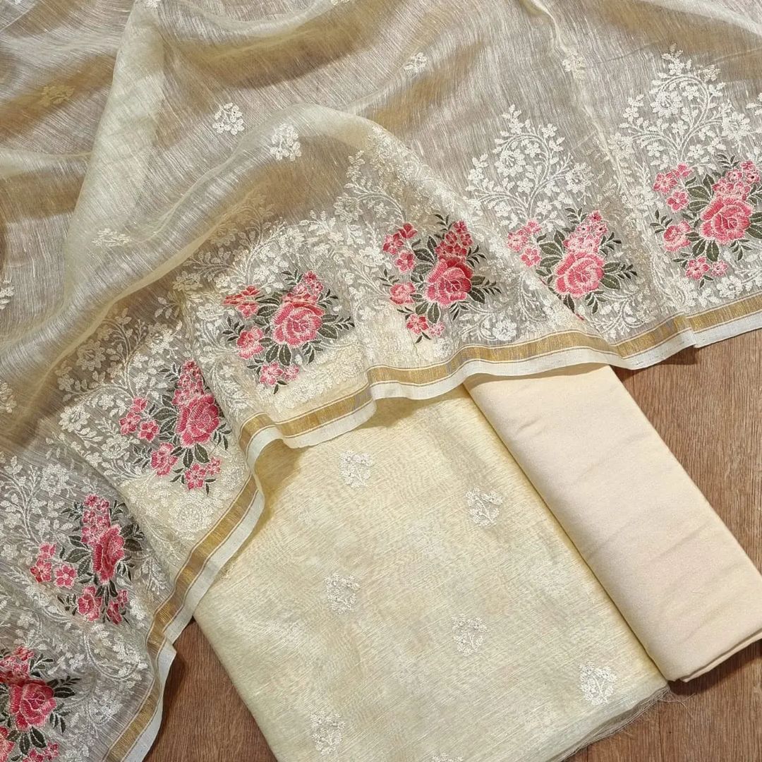 Embroidered fabric with floral patterns on a wooden surface