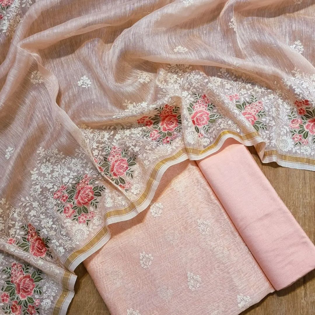 Embroidered fabric with floral patterns on a wooden surface