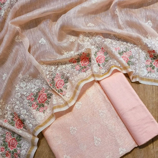 Embroidered fabric with floral patterns on a wooden surface