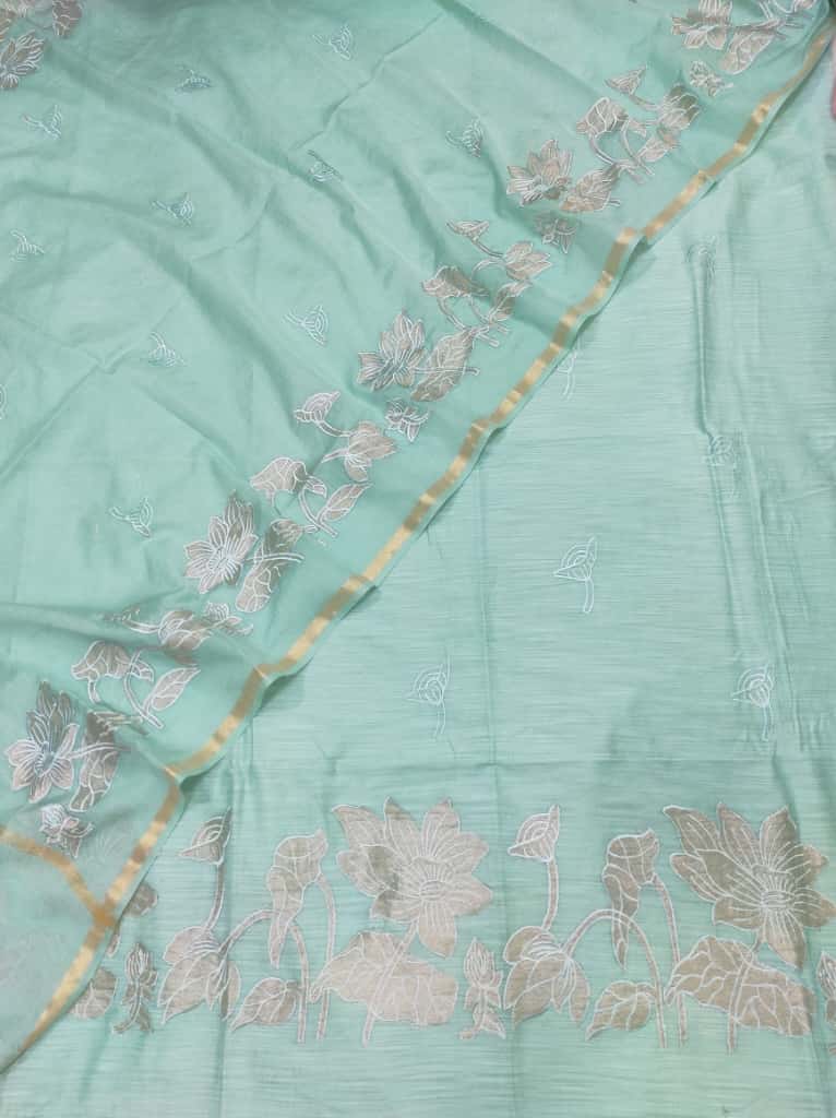 Light blue fabric with floral embroidery and a gold border