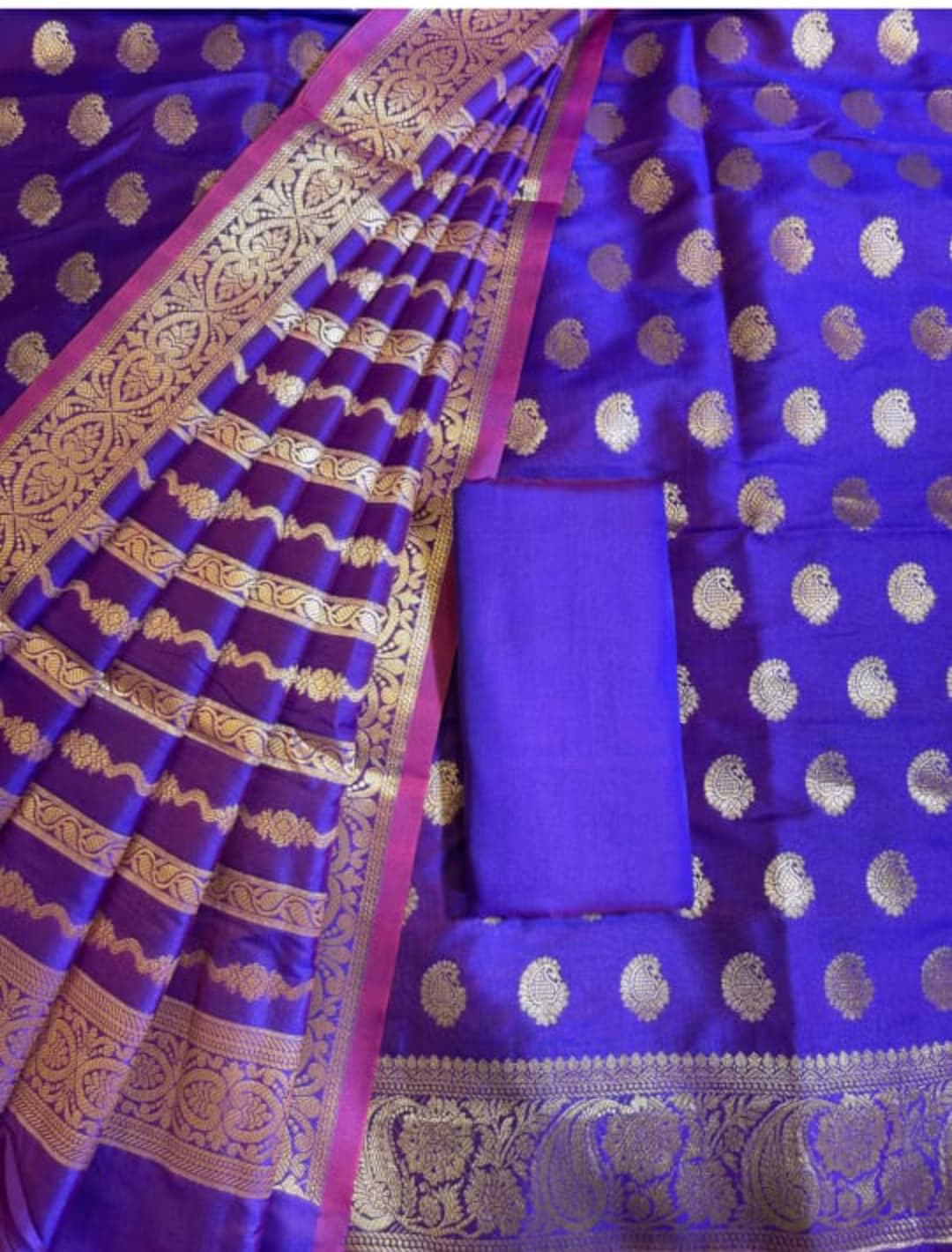 Blue saree with gold patterns and a matching blouse piece.