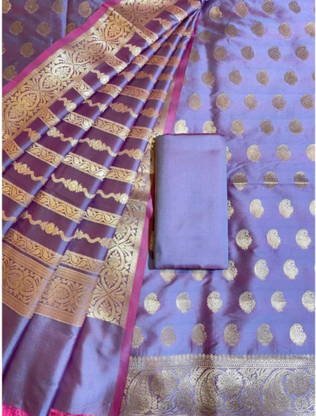 Purple saree with gold patterns and a matching blouse piece.