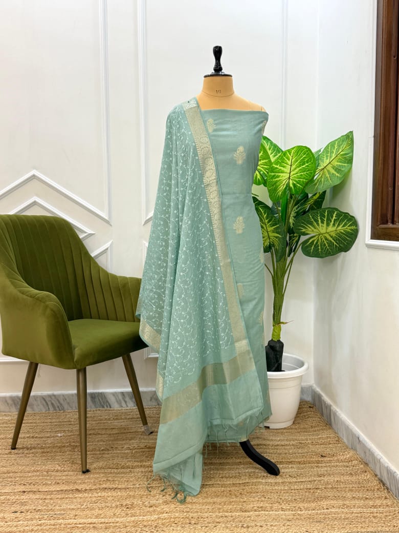 Light blue saree with green chair and plant in the background