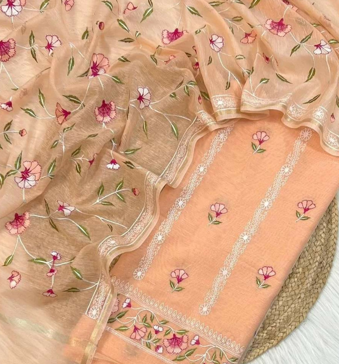 Delicate fabric with floral embroidery on a beige background