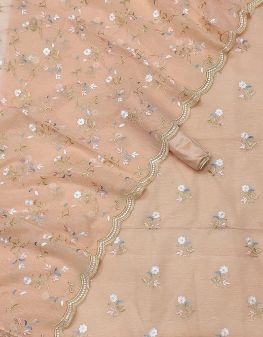 Delicate peach fabric with floral patterns and decorative border