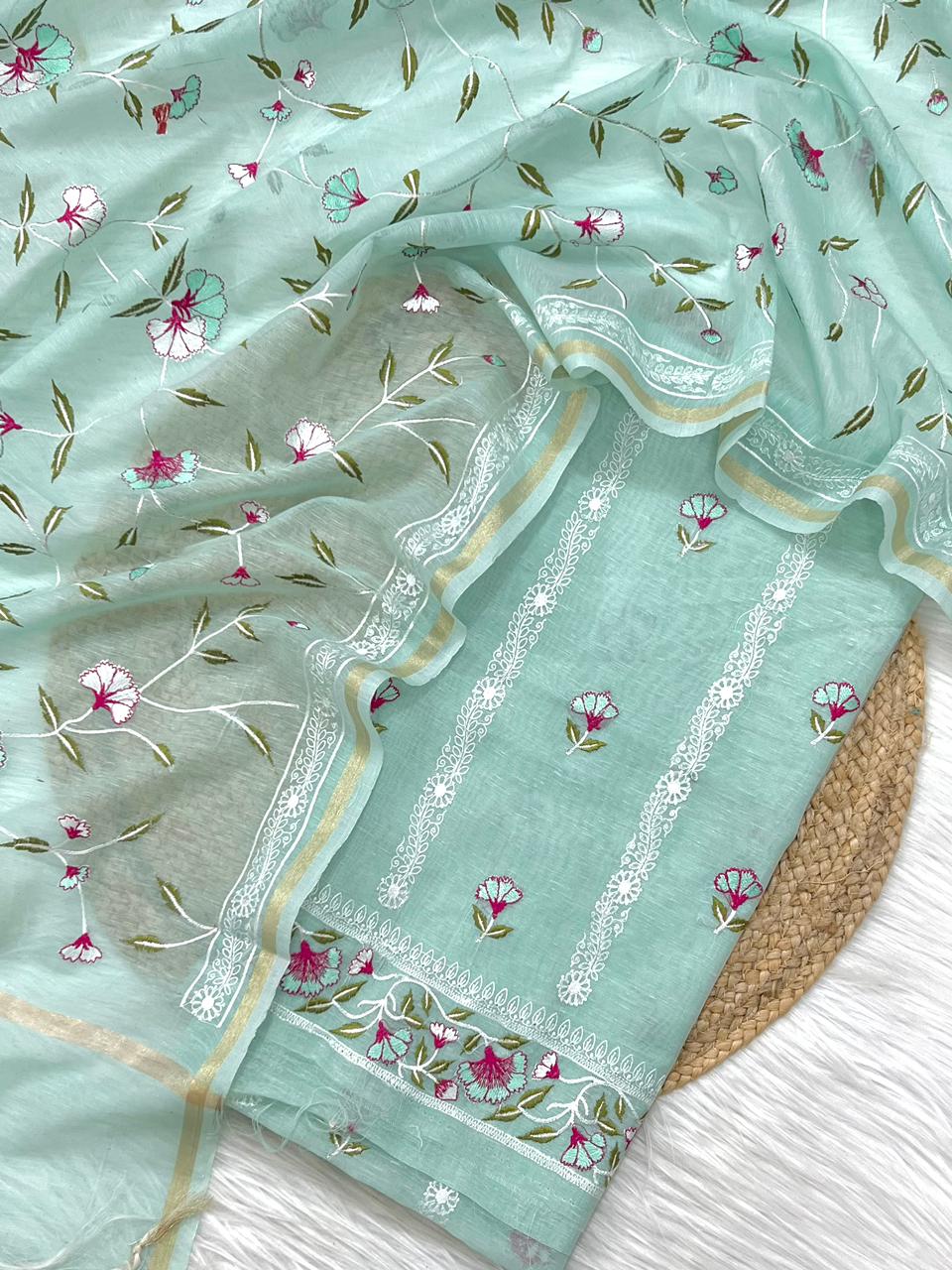 Light blue fabric with floral patterns on a textured surface