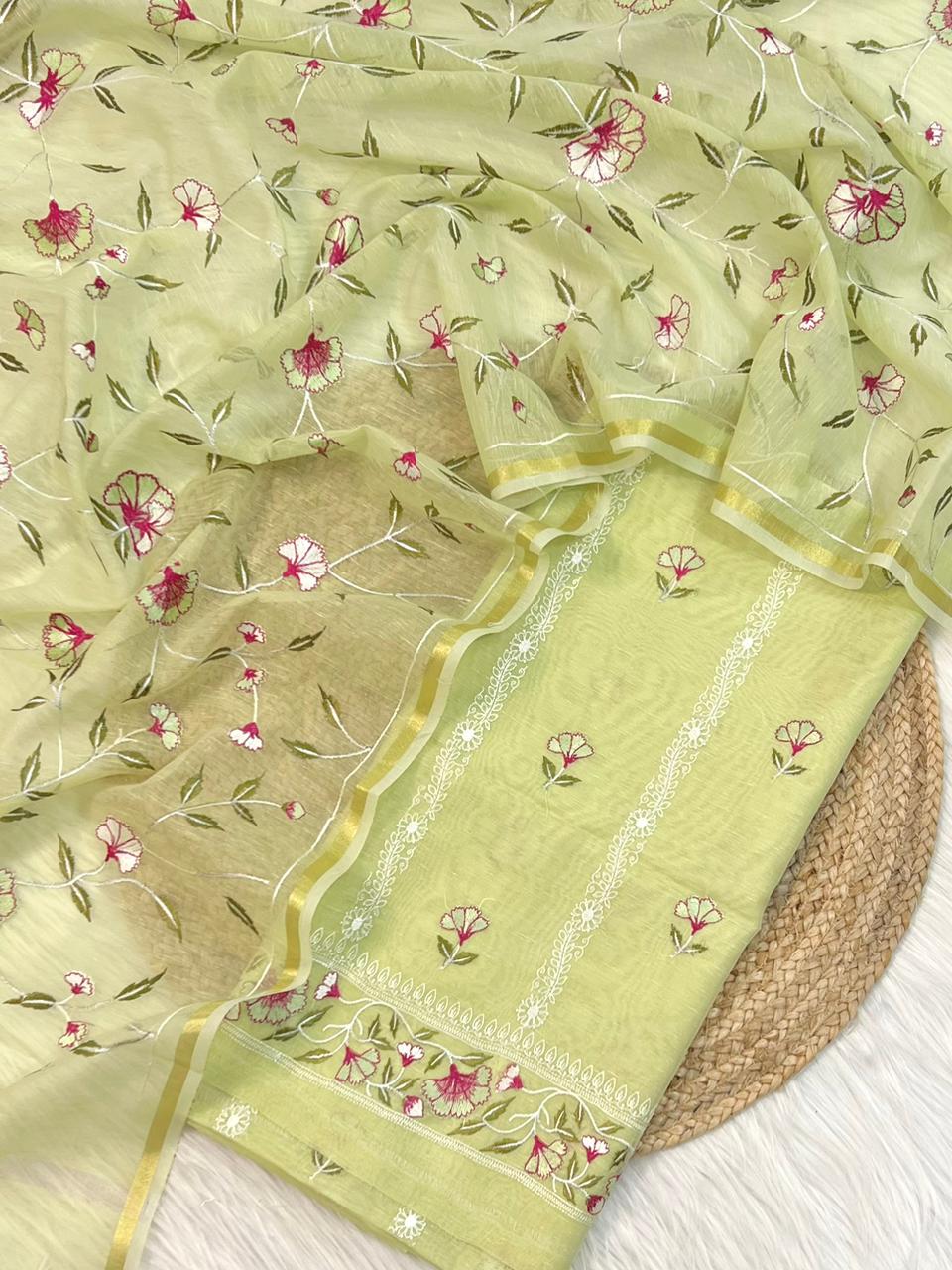 Light green fabric with floral patterns on a woven surface
