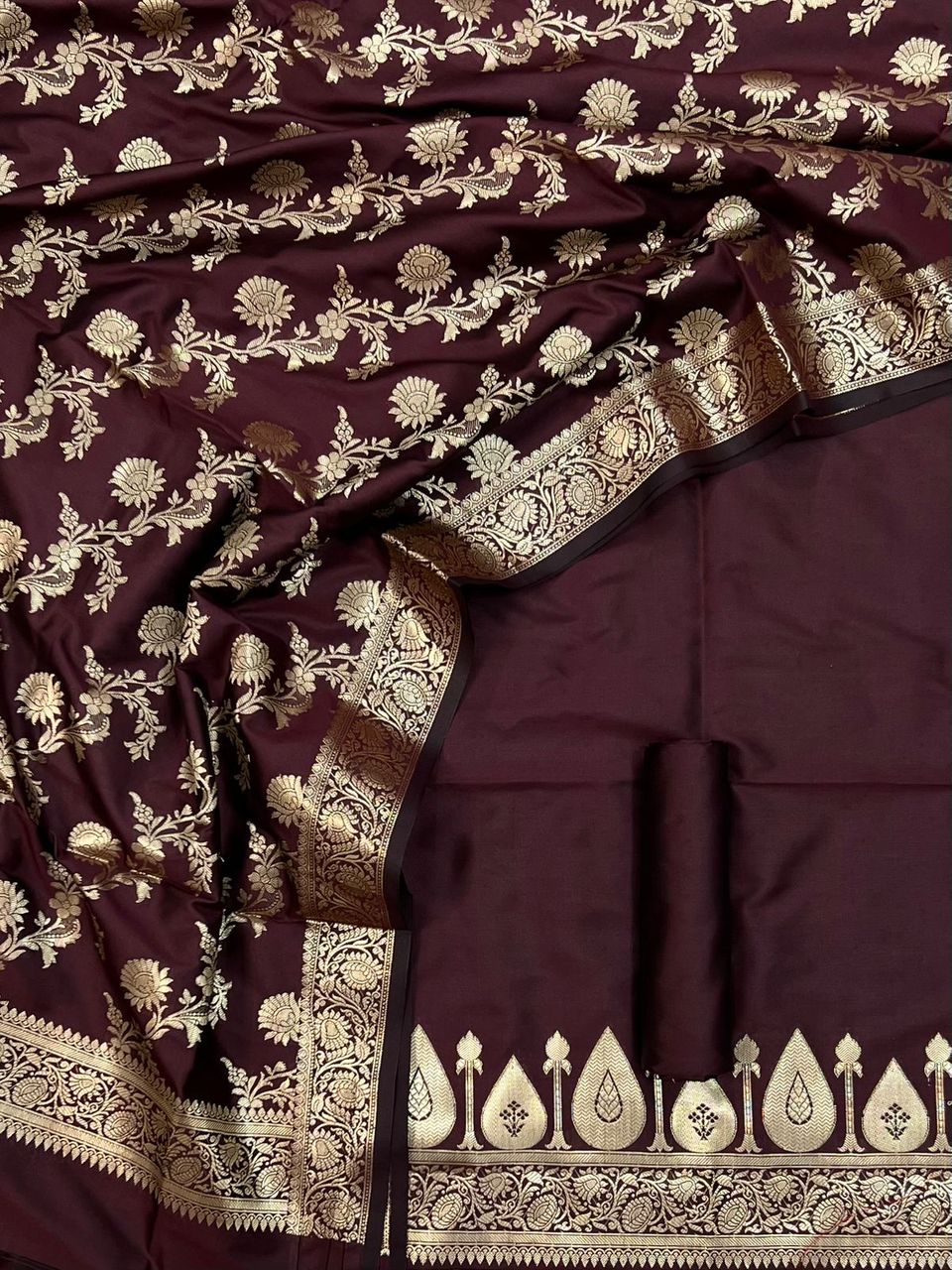 Maroon saree with gold and white floral patterns