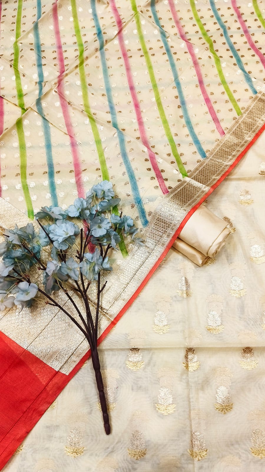 Decorative fabric with colorful stripes and a plant on a textured surface