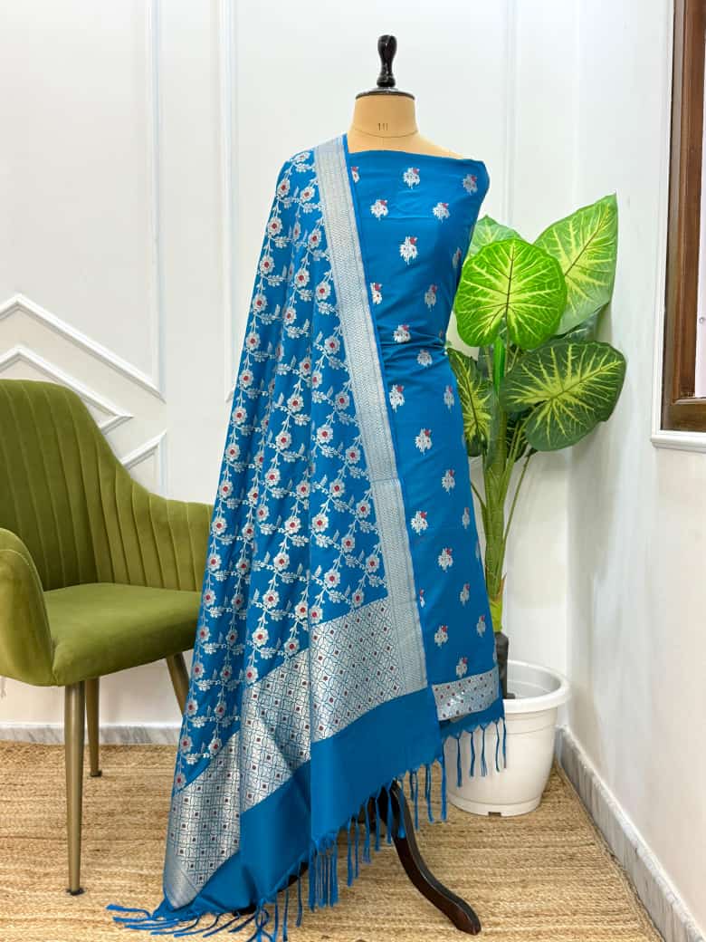 Blue floral saree with white patterns on a mannequin against a white wall.