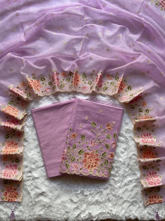 Pink embroidered fabric with floral patterns on a textured surface