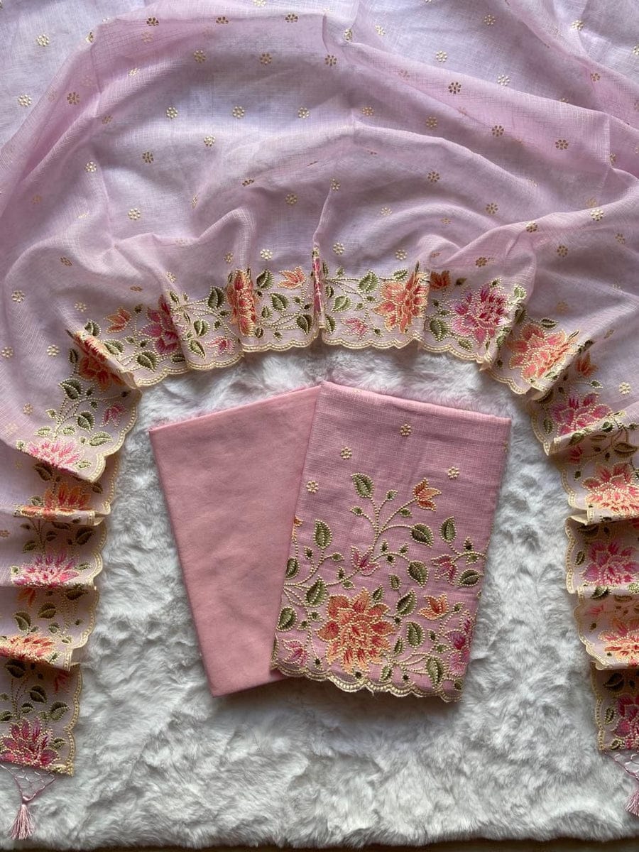 Pink fabric with floral embroidery on a textured surface