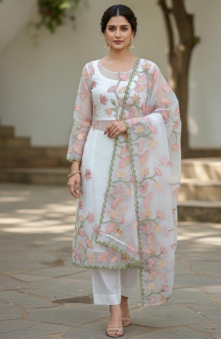 Woman wearing a traditional outfit with floral embroidery in an outdoor setting