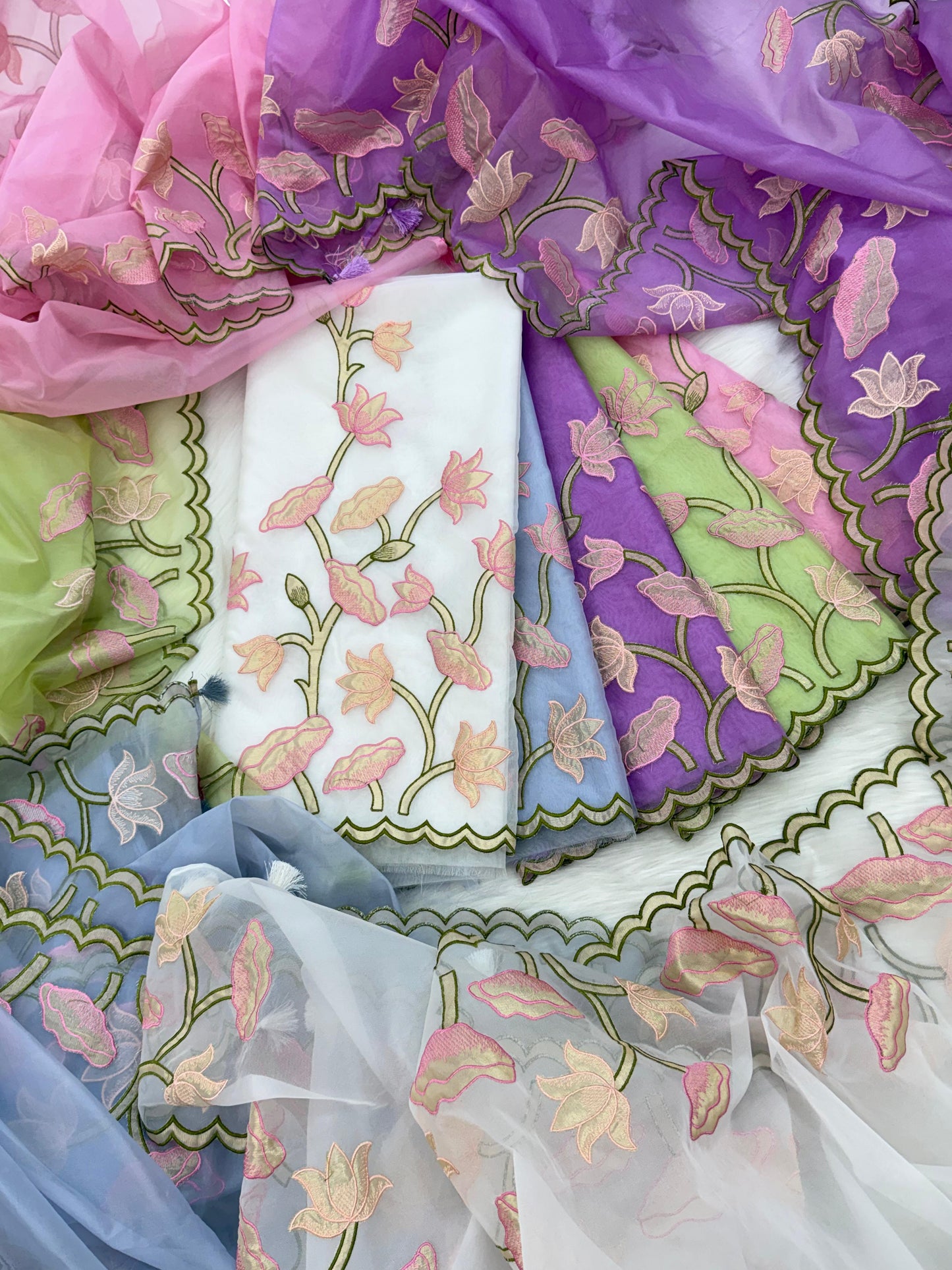 Colorful fabric with floral embroidery arranged in a circular pattern.