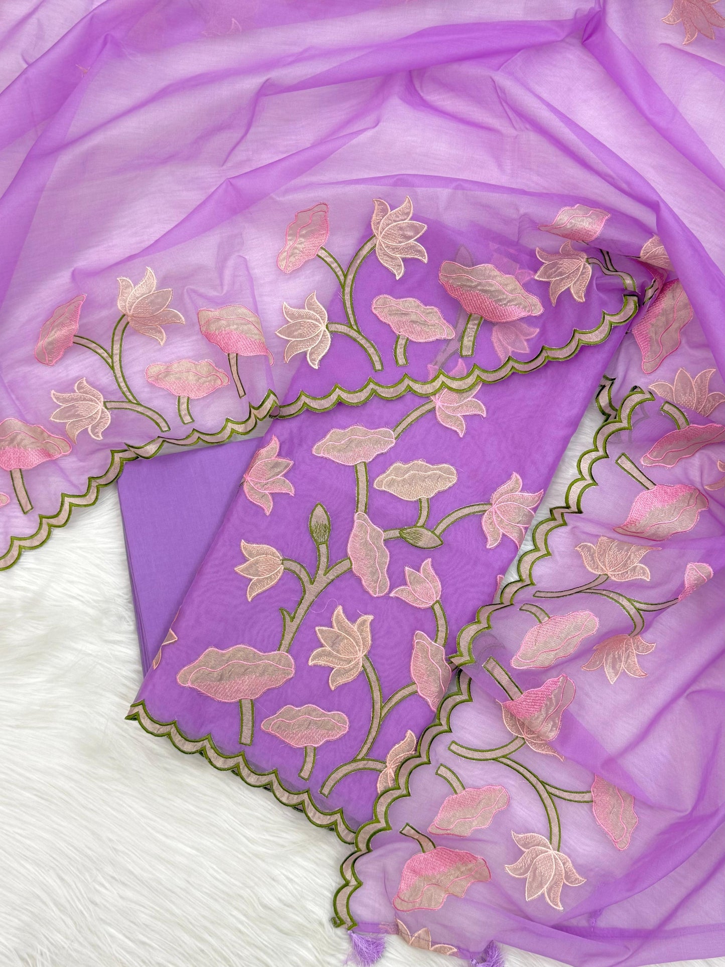 Purple fabric with floral embroidery on a white background