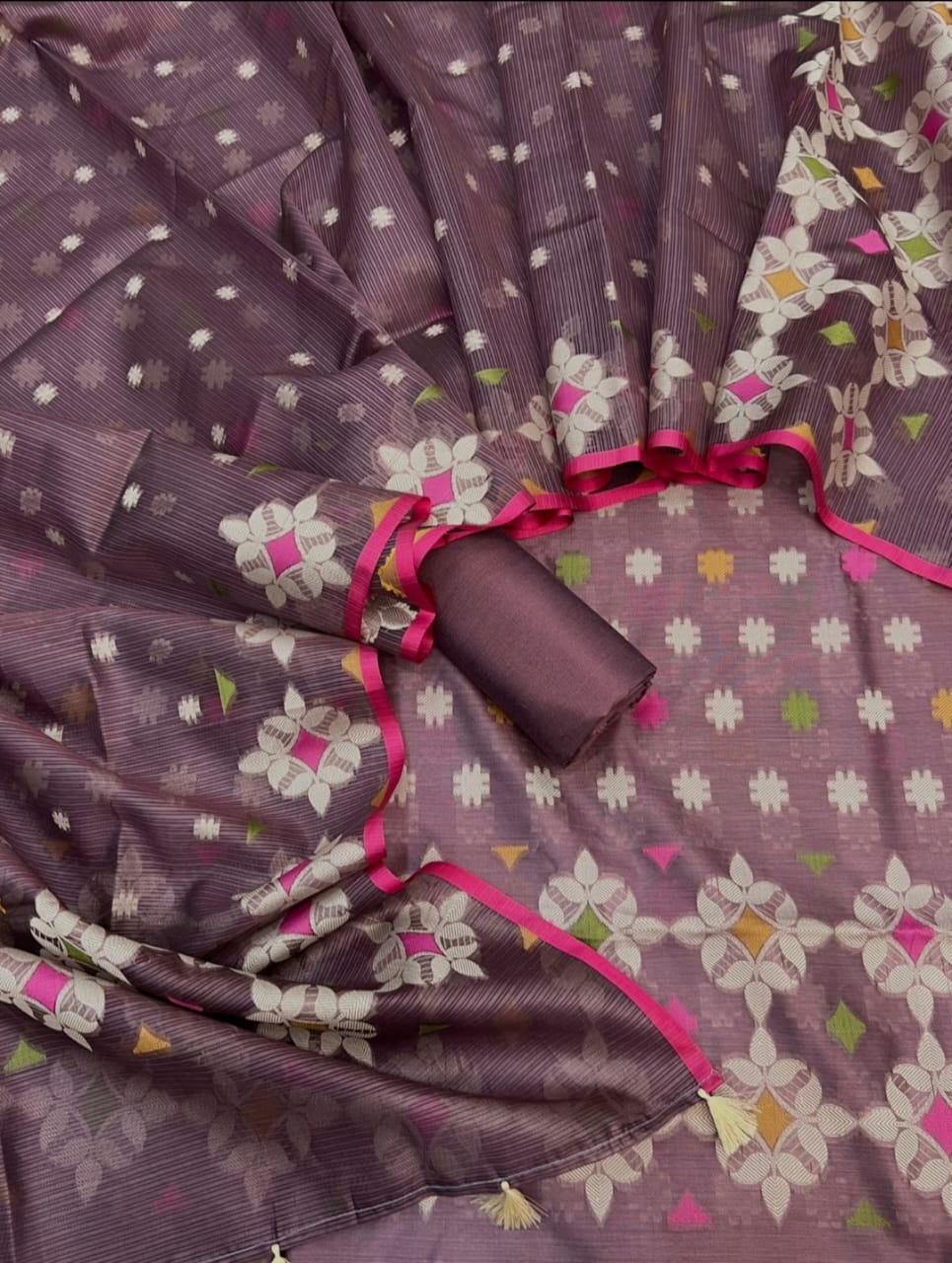 Purple fabric with floral patterns and pink accents