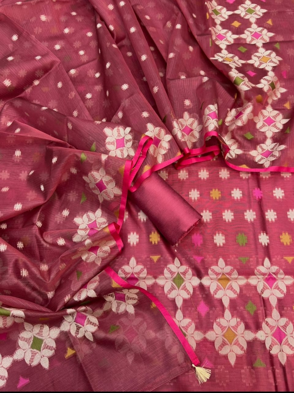 Maroon saree with white floral patterns and pink border