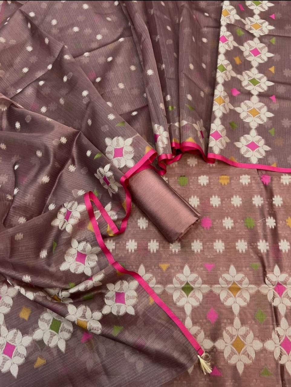 Brown saree with white floral patterns and pink border