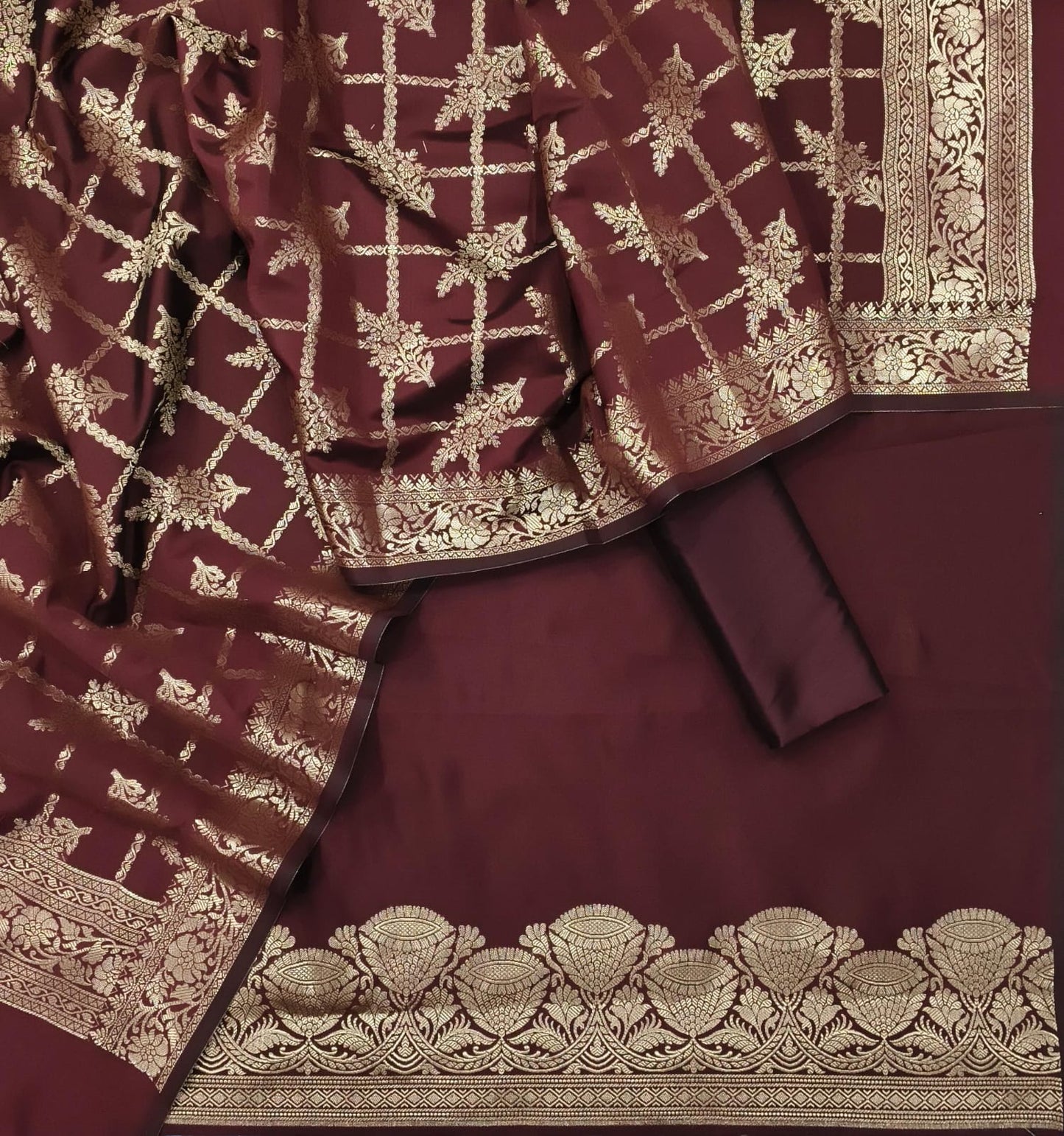 Maroon fabric with gold embroidery and patterns