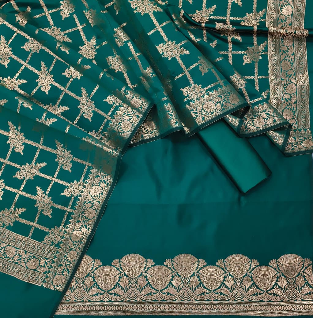 Teal saree with gold embroidery on a plain background