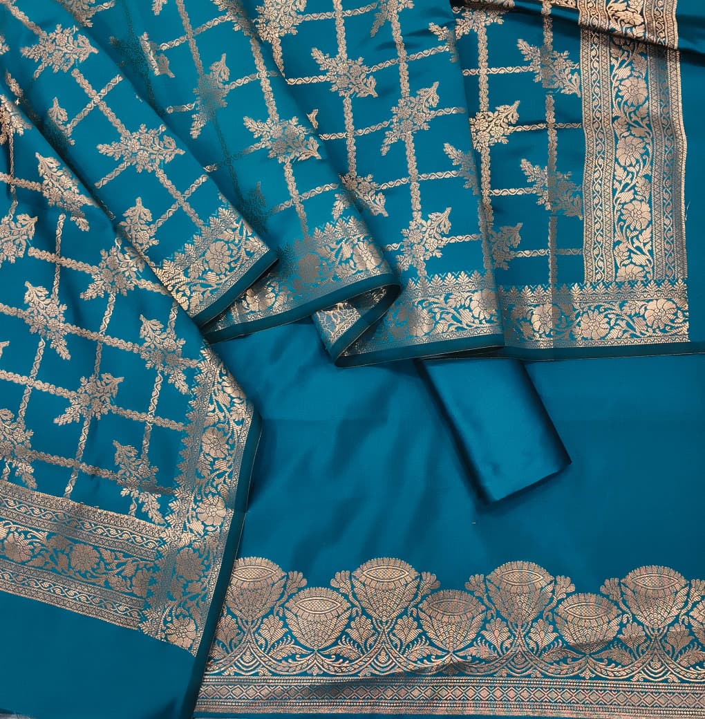 Blue saree with intricate gold patterns on a plain background