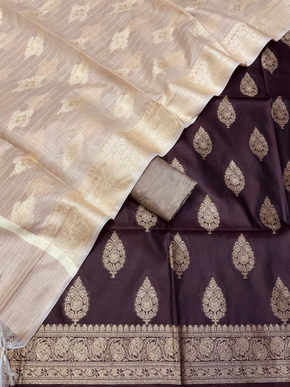 Two sarees with intricate patterns, one beige and one brown with gold designs.
