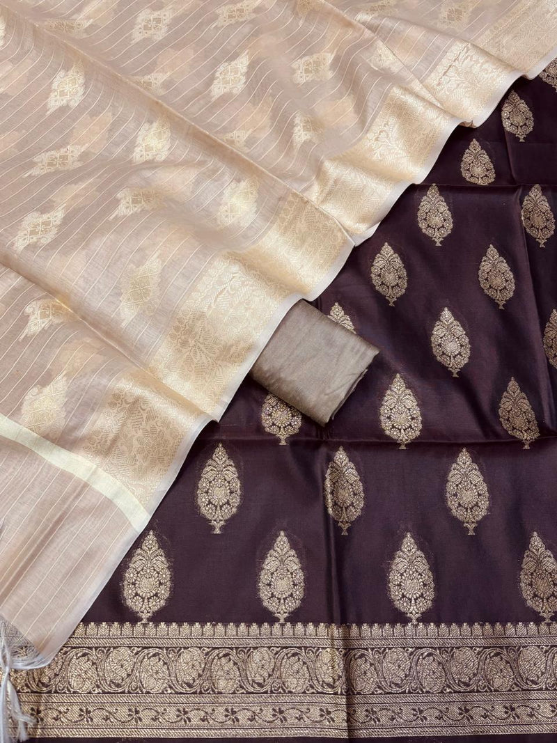 Two sarees with intricate patterns, one beige and one brown with gold designs.