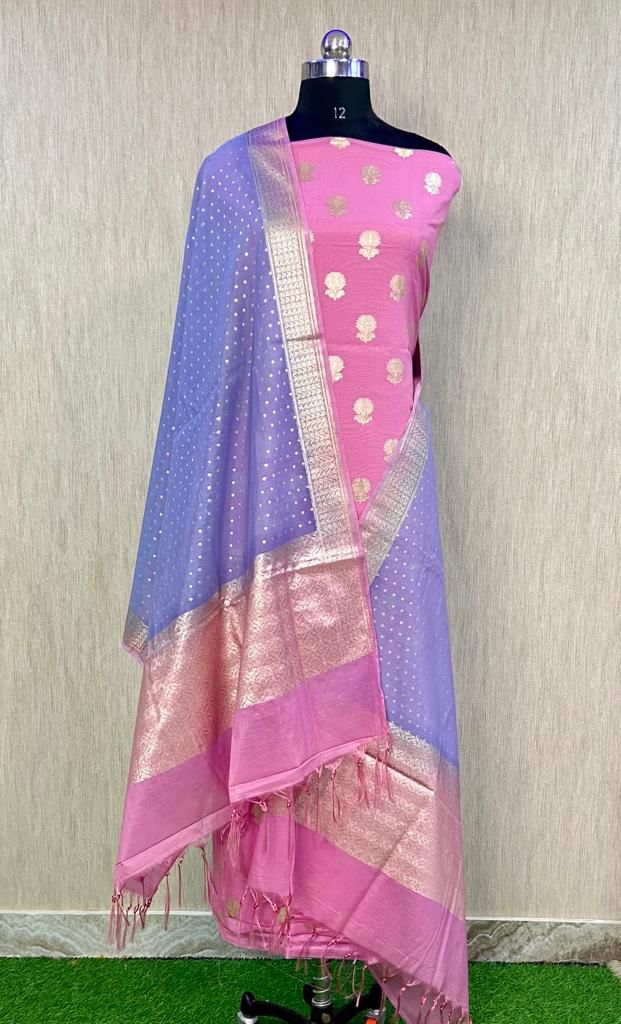 Mannequin wearing a pink and blue saree with a subtle pattern against a neutral background