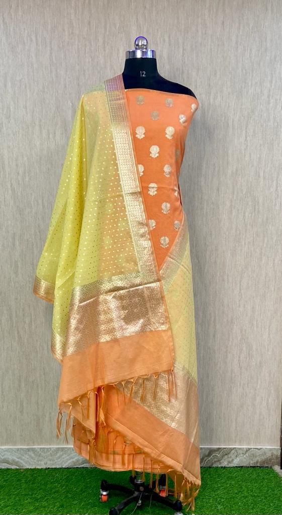 Saree with a gradient of green to orange on a mannequin against a neutral background
