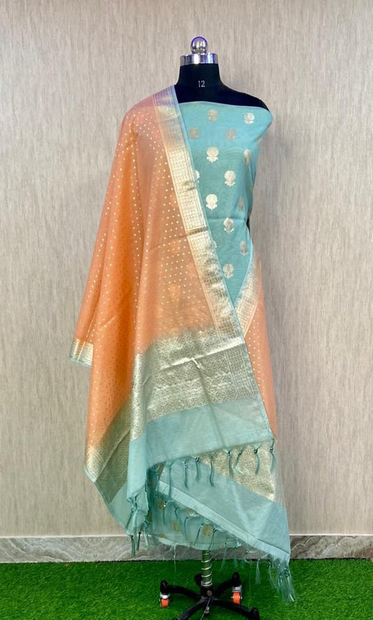 Teal saree with gold border on a mannequin against a neutral background