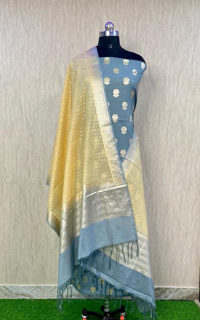 Mannequin wearing a yellow and blue saree with a subtle pattern on a neutral background