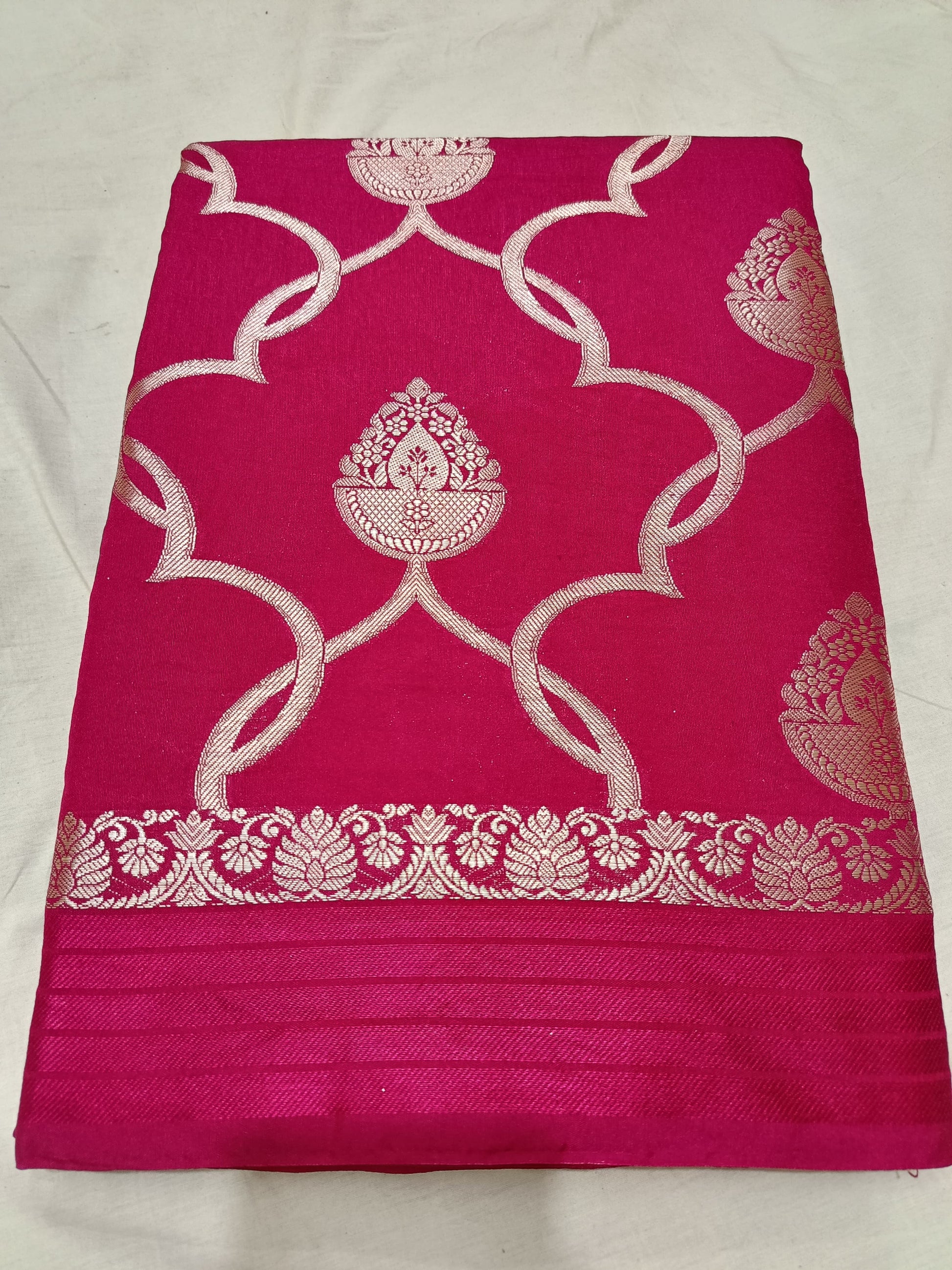 Pink fabric with white floral patterns on a white background