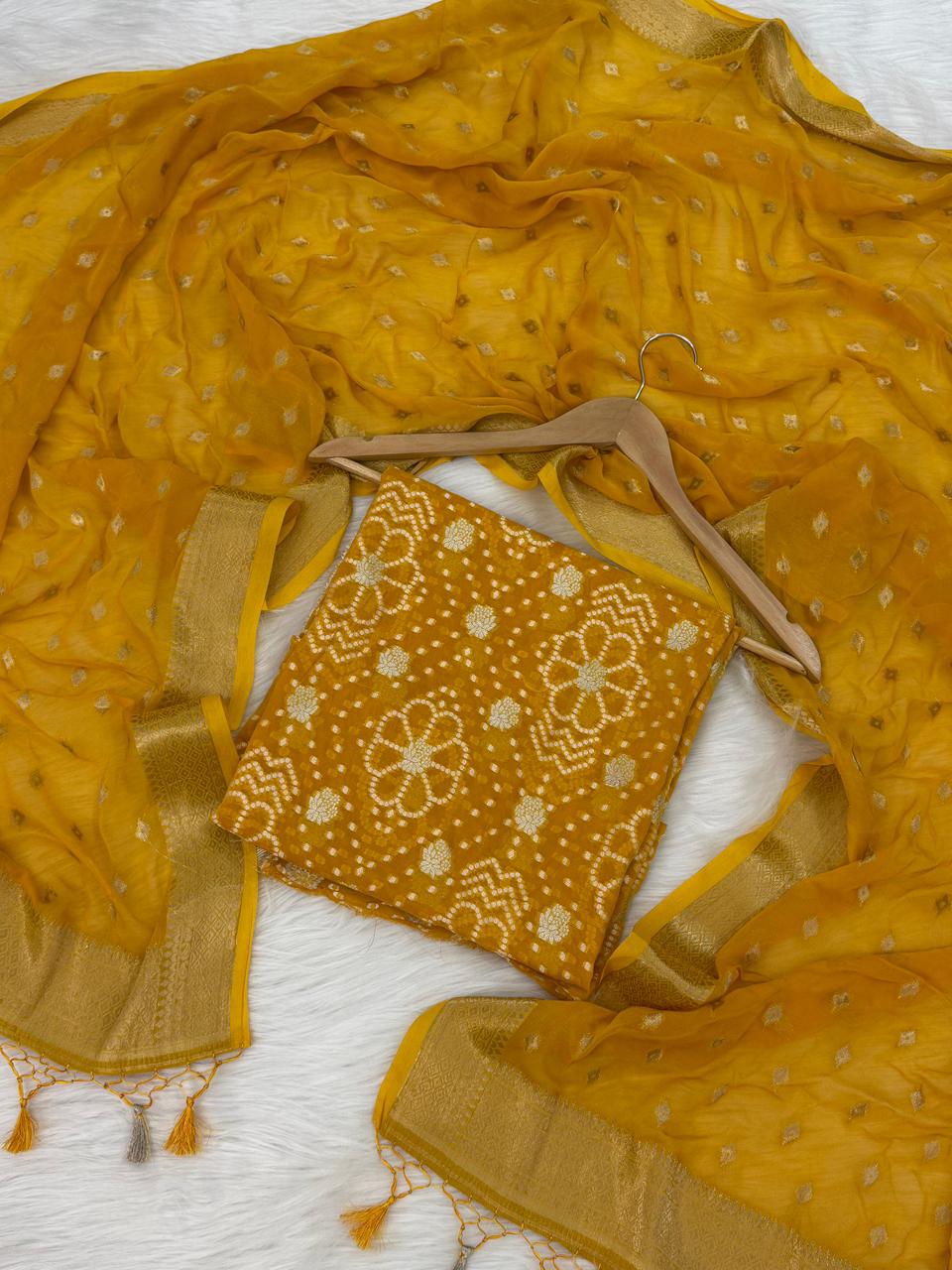 Mustard yellow fabric with embroidered piece on a white background