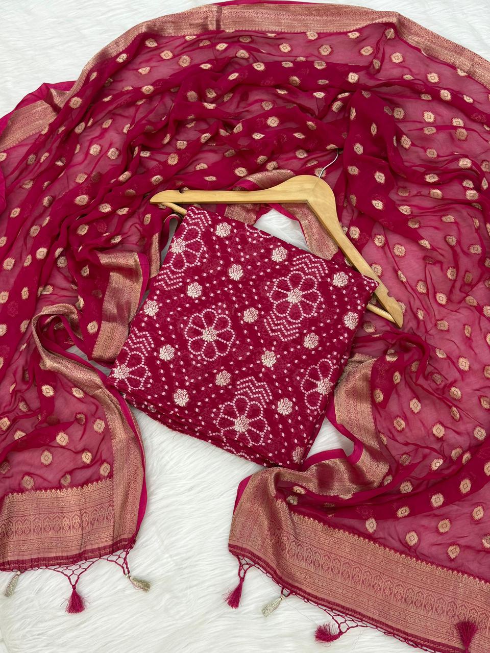 Red saree with gold patterns on a white background