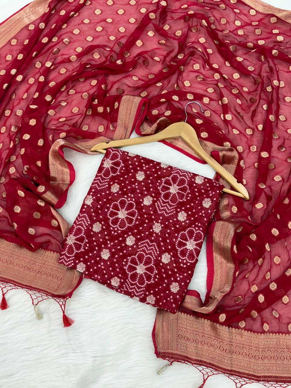 Red patterned fabric with a hanger on a white background