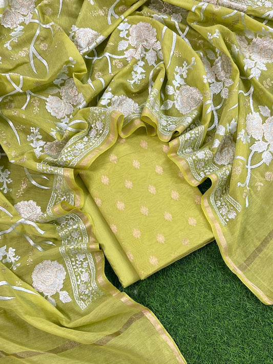 Green fabric with floral patterns on a green background