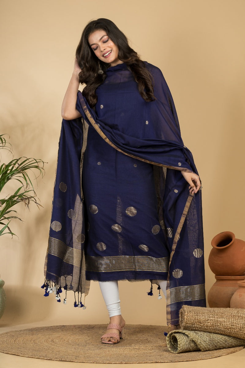 Woman wearing a navy blue traditional outfit with a beige background