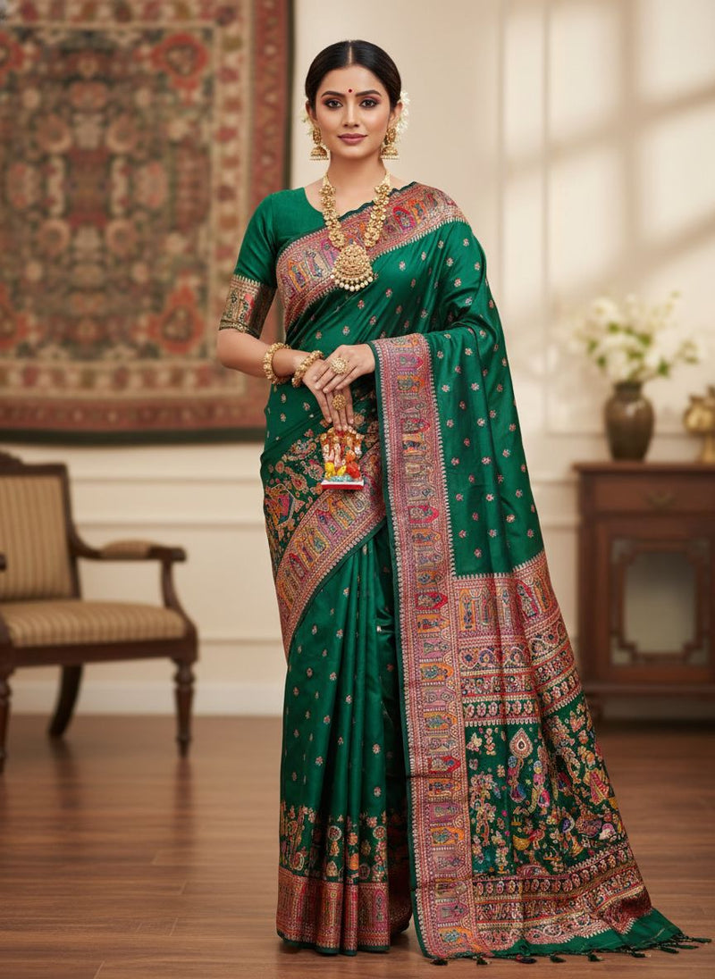 Woman in a green saree with intricate patterns in a decorated room.