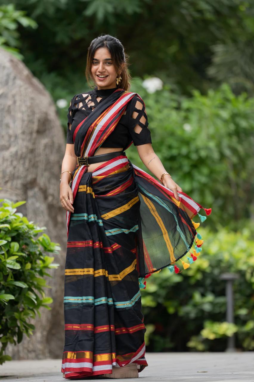 Woman wearing a colorful saree with a black blouse in an outdoor setting