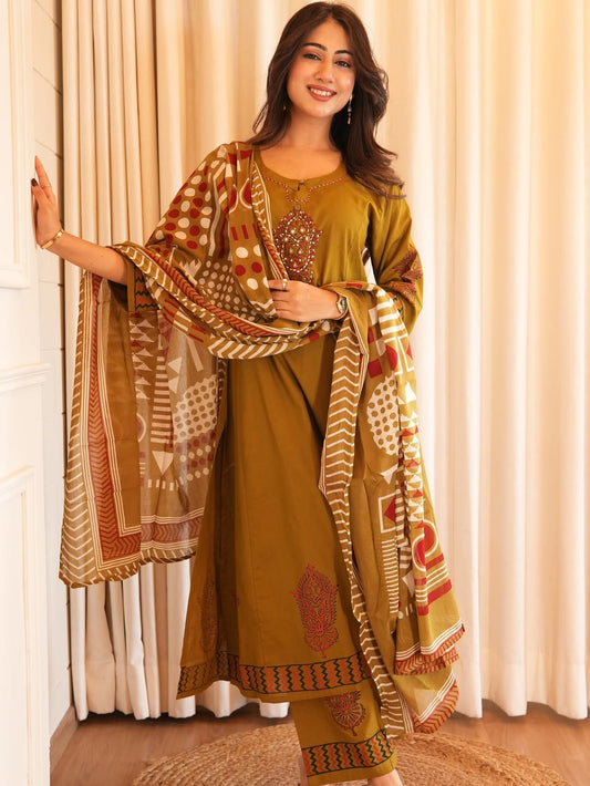 Woman wearing a traditional outfit with a patterned dupatta against a neutral background