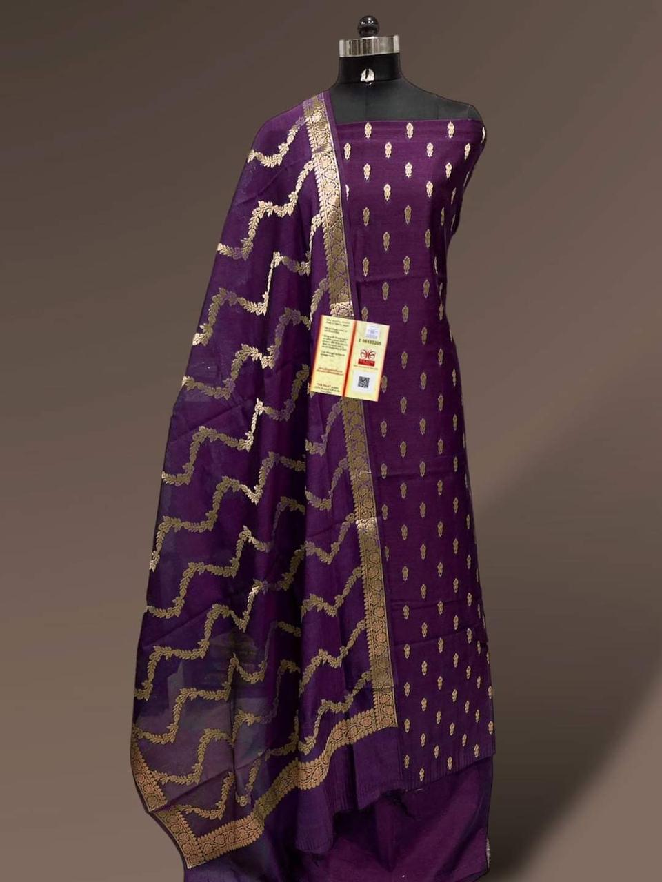Purple traditional outfit with gold patterns on a mannequin against a gray background