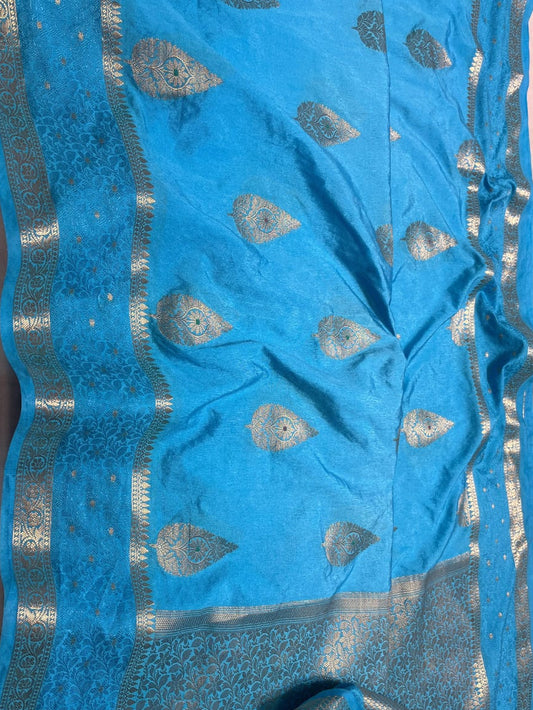 Blue fabric with silver patterns on a pink background