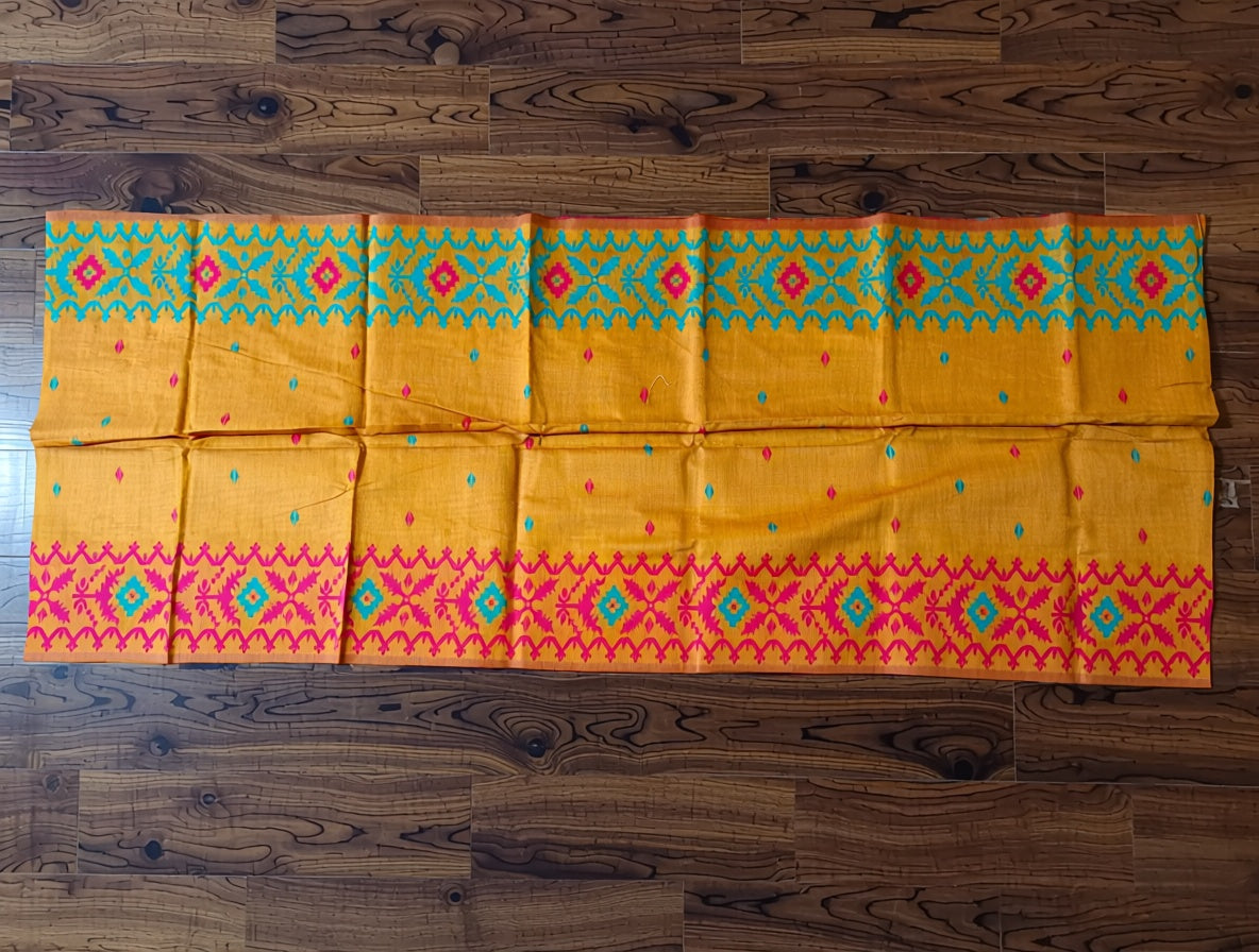 Yellow fabric with colorful patterns on a wooden surface