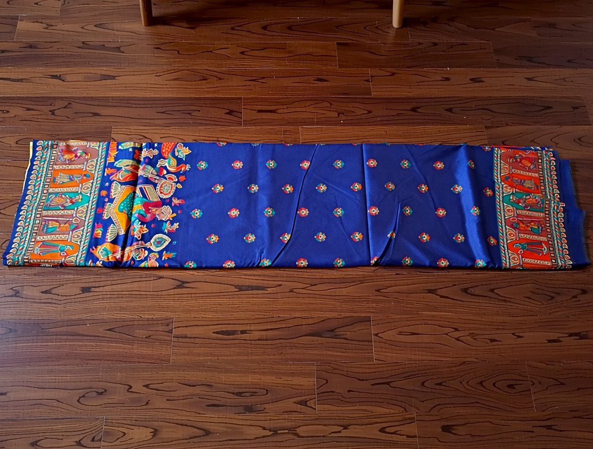 Colorful fabric with intricate patterns on a wooden floor